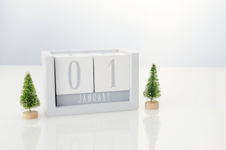 1 january wooden calendar with decorations on white table backgroundの写真素材