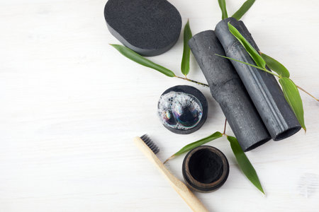 Bamboo charcoal eco friendly cosmetics products. Toothbrush and soap with skin cleansingの写真素材