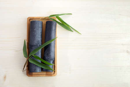 Natural Bamboo ativated charcoal on white wooden backgroundの写真素材