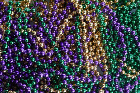 Colorful Mardi gras beads background. Green, purple and gold Merdi gras beadsの写真素材