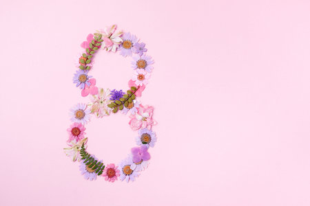 International Womens Day. Flowers in the shape of the number 8 on a pink background.