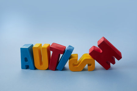 Autism awareness concept. Word autism on blue background.