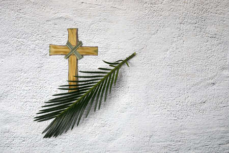Palm sunday background. Cross and palm on grey background.の写真素材