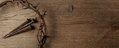 Crown of thorns with three nails on wooden background. Easter concept.の写真素材