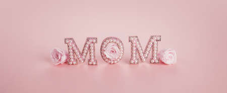 Happy Mothers day banner. Mom word with pink roses. Holiday background.の写真素材