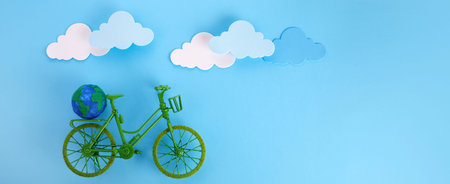 3rd June World Bicycle Day. Green bicycle on blue background. Environment preserve.