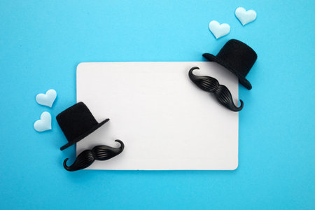 Happy Fathers Day greeting card of white frame with decoration. Includes mustache, hat and hearts.の写真素材