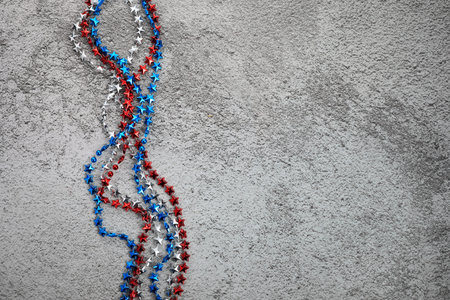American Independence Day red blue white stars beads on on Dark Concrete Background. USA flag colors stylish fourth of july wallpaper.の写真素材
