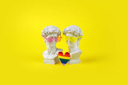 The concept of the Prade lgbt pride festival. Two David sculptural heads with sunglasses and a rainbow heartの写真素材
