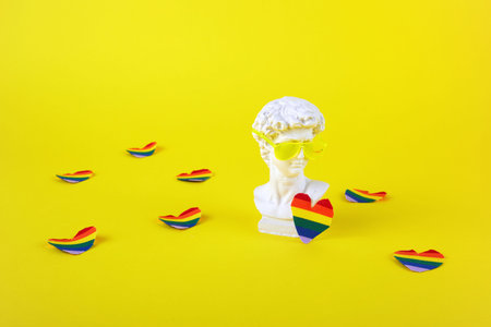 The concept of the Prade lgbt pride festival. David sculptural head with sunglasses and a rainbow...