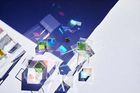 Abstract background with glass geometric figures prisms with light diffraction of spectrum colors and complex reflection.の写真素材