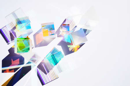 Abstract background with glass geometric figures prisms with light diffraction of spectrum colors and complex reflection.の写真素材