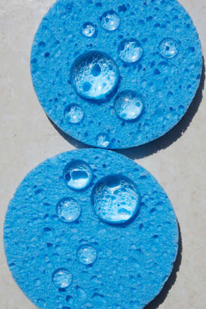 Blue sponge close up with water drops. Face Cleansing and Make Up Removing Beauty Routineの写真素材
