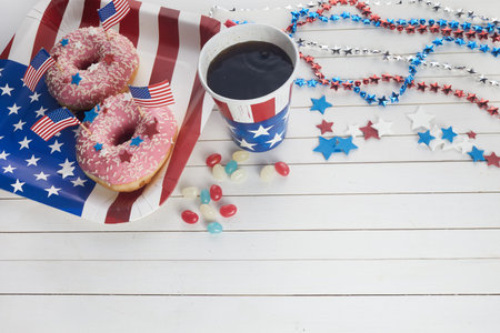American independence day, celebration, patriotism and holidays concept. Sweet donut with candies in...