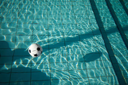 Beach ball in pool. Inflatable ball floating in swimming pool.の写真素材