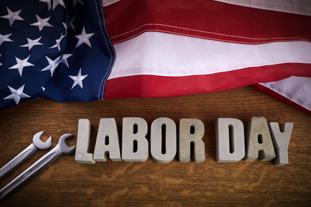 Happy Labor Day banner. USA flag and letters on rustic wooden background.