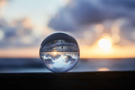 Magic sphere. Fortune teller, mind power concept. Crystal Ball reflecting water and sky.の写真素材