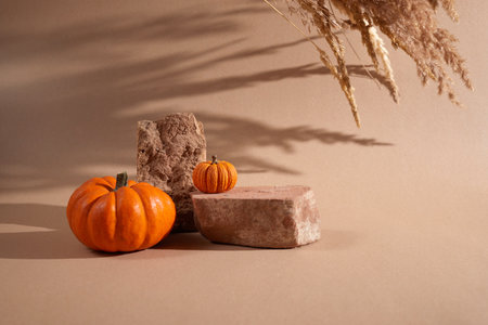 Halloween background podium display with pumpkins on biege background. Cosmetic, beauty product promotion autumn pedestal with shadowsの写真素材
