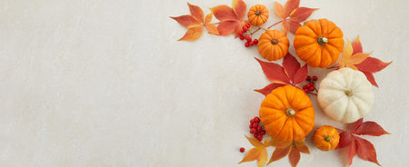 Autumn framework from pumpkins, berries and leaves on a travertine background. Concept of...