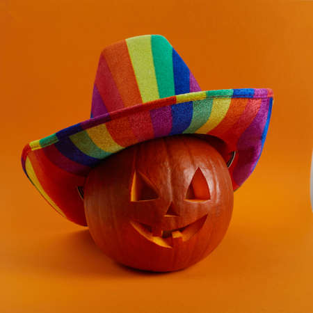 LGBTQ color hat on pumpkin, background for Halloween.の写真素材