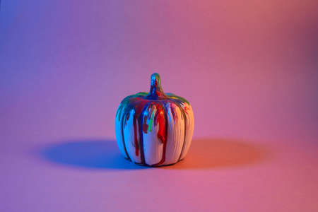 Halloween pumpkin with on neon light background. Minimal concept.の写真素材