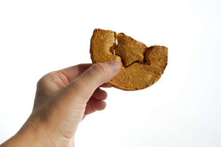 Hand holding Korean Dalgona honeycomb sugar cookies and to play new trend candy challengeの写真素材