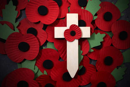 Remembrance Day poppy symbol on wooden cross. 11th November is a memorial day of the First World War.の写真素材