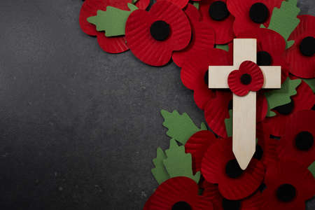 Remembrance Day poppy symbol on wooden cross. 11th November is a memorial day of the First World War.の写真素材