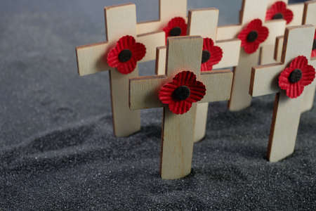 Remembrance Day poppy symbol on wooden cross. 11th November is a memorial day of the First World War.の写真素材