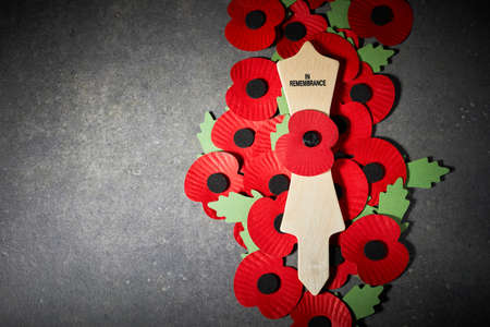 Remembrance Day poppy symbol on wooden cross. 11th November is a memorial day of the First World War.の写真素材