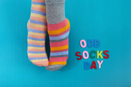 Odd Socks Day. Day lost socks, lonely socks on blue background.の写真素材