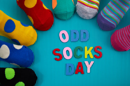 Odd Socks Day. Day lost socks, lonely socks on blue background.の写真素材