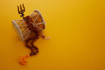 Shivaratri background with Shivas trident and Pellet Drum Damroo musical instrument . Hindu festival Maha Shivratriの写真素材
