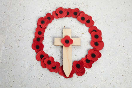 Anzac day. Australian and New Zealand national public holiday or Remembrance day. Red poppies wreath on biege stone backgroundの写真素材