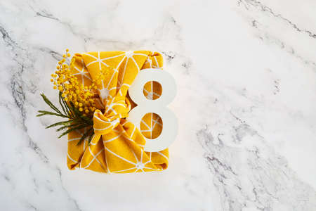 Greeting for International Womens Day on March 8th. Branches of mimosa and number eight.の写真素材