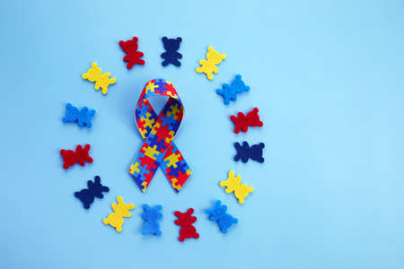 Autism awareness concept with colorful teddy bears on blue background. Top viewの写真素材