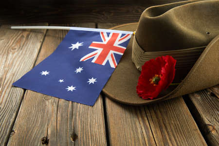 Anzac army slouch hat with Australian Flag and Poppy on wooden backgroundの写真素材