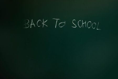 Back to school text drawing by chalk in blackboard