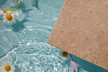 Product promotion Beauty cosmetic showcase. Travertine stone display with flowers in water.