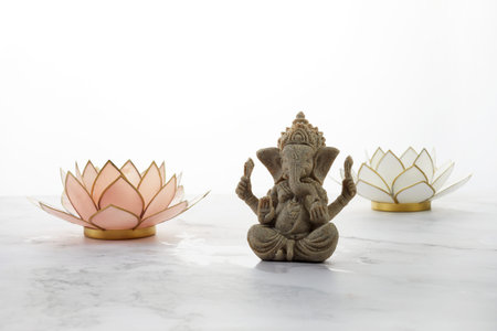 Happy Ganesh Chaturthi festival, Lord Ganesha statue with lotus on marble background,