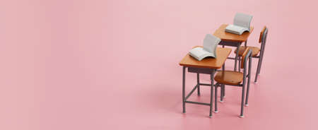 School desk with books on pink backgroundの写真素材