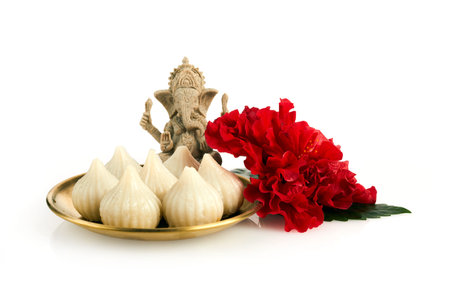 Idol of lord Ganesha with Modak Sweet Dish and flower. Ganesh chaturthi