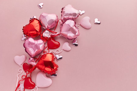 Air Balloons of heart shaped foil on pink background. Love concept. Valentines Day.の写真素材