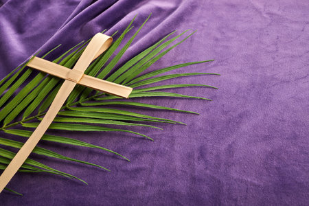 Lent season, Holy week and Good friday concept. Palm leave and cross on purple backgroundの写真素材