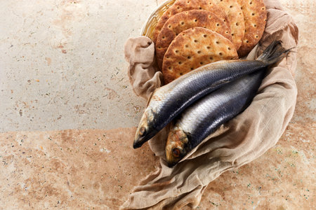 Catholic still life of five loaves of bread and two fishの写真素材
