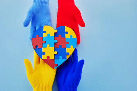 Hands holding jigsaw puzzle heart shape, Autism awareness, World Autism Awareness Dayの写真素材