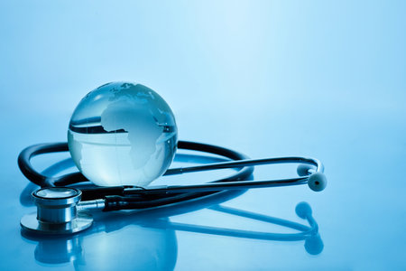 World Health Day. Global Health Awareness Concept. Globe and Stethoscope on blue background.の写真素材