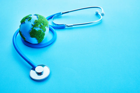 World Health Day. Global Health Awareness Concept. Globe and Stethoscope on blue background.の写真素材