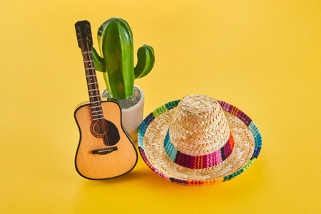 Cinco de Mayo holiday background. Cactus, guitar and hat on yellow background.の写真素材