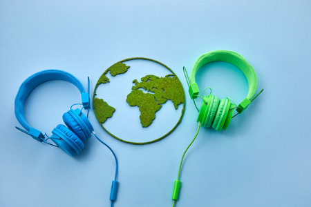 World music day concept. Stereo headphone and a globe on a blue backgroundの写真素材